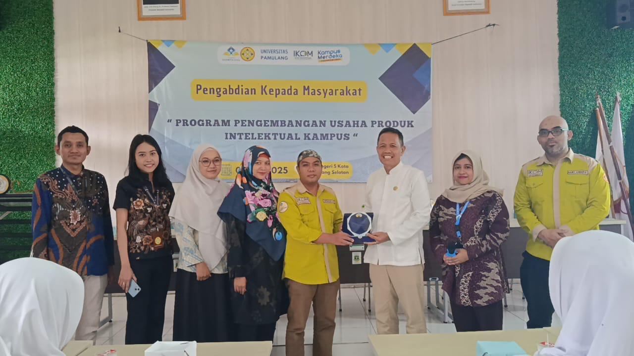 Foto Caption: SERAHKAN PLAKAT – Kepala Perwakilan Kelompok PkM FIKOM UNPAM, Hermansyah, S.Sos., M.I.Kom., menyerahkan plakat kepada Wakil Kepala SMKN 5 Tangsel bidang Kehumasan, Rudy Darmawan, S.Pd., sebagai tanda diterimanya kegiatan PkM di sekolah tersebut.